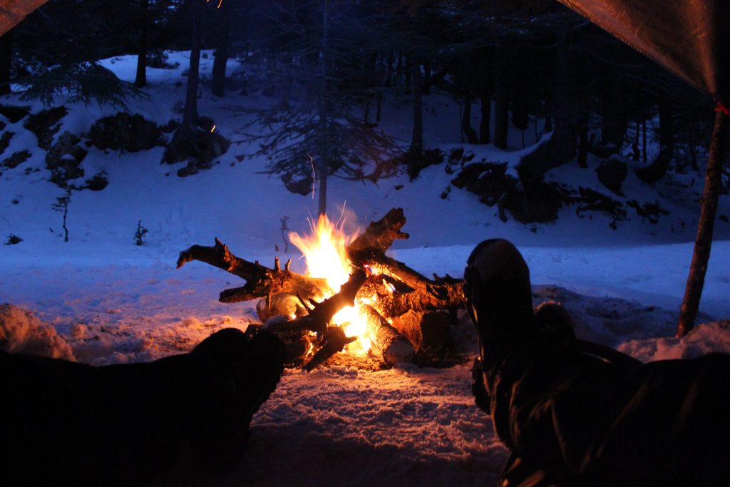 Snow camping by the fire